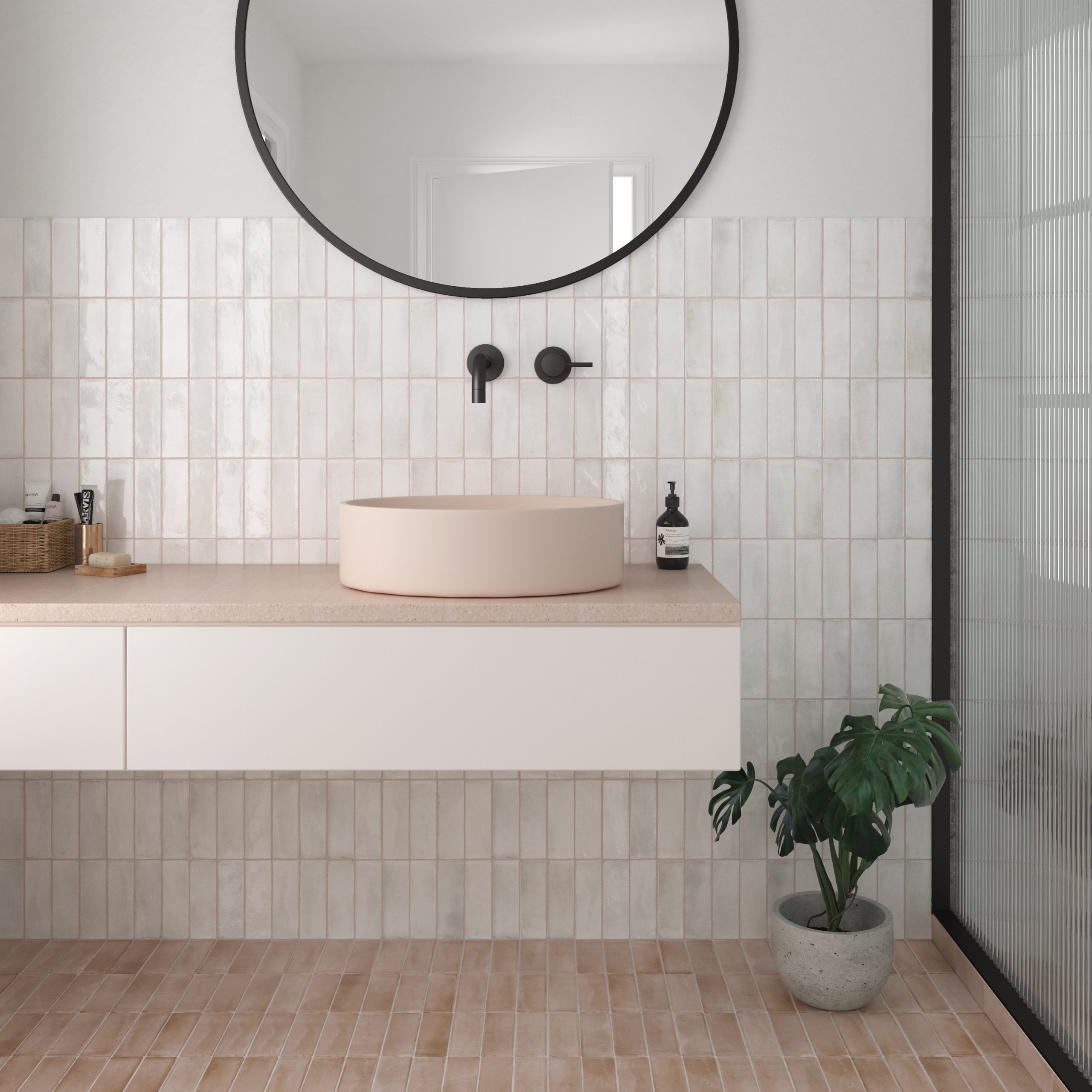 White zellige-look wall tiles in a bright bathroom with a round basin and black tapware